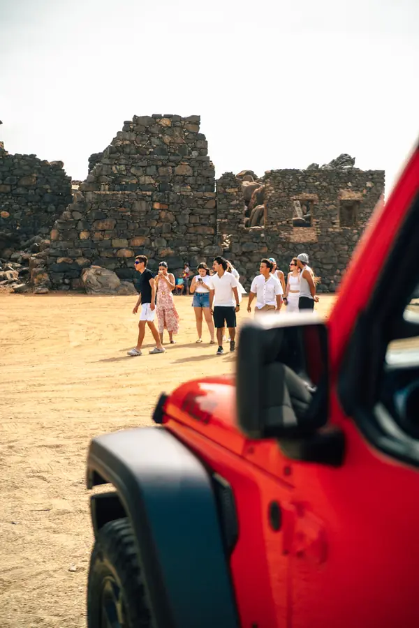 Friends at the Bushiribana gold mill ruins next to an EFE Jeep